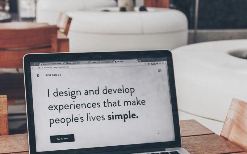 How much does a website cost: laptop with code beside a phone on a desk