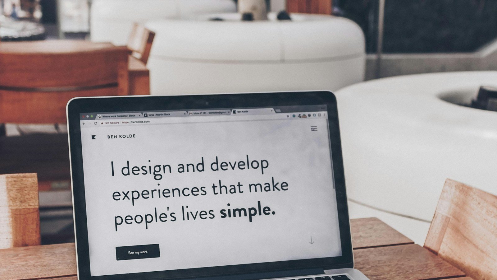How much does a website cost: laptop with code beside a phone on a desk